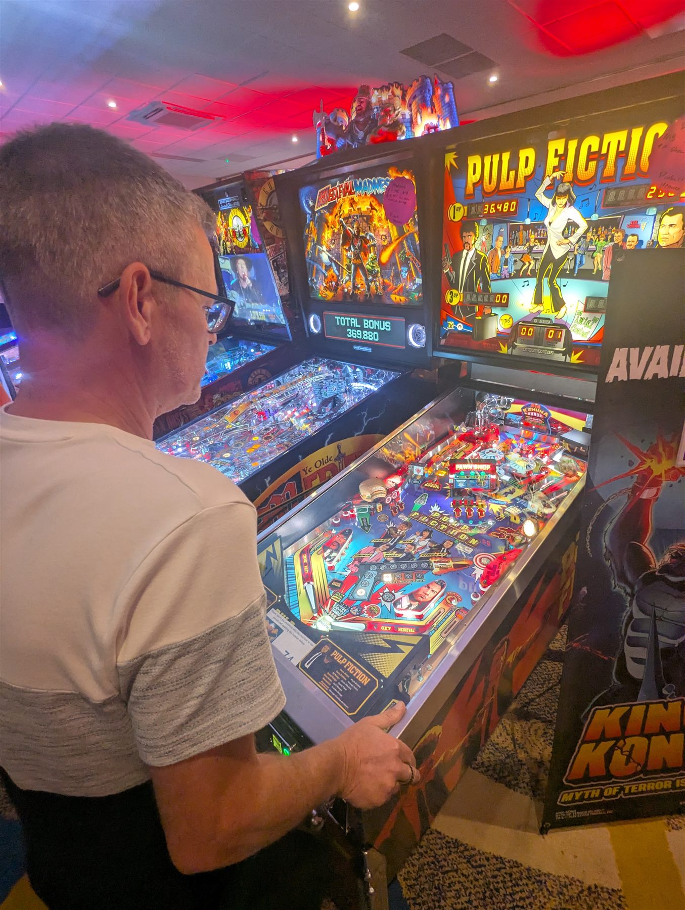 Player enjoying Pulp Fiction pinball at UK Pinfest